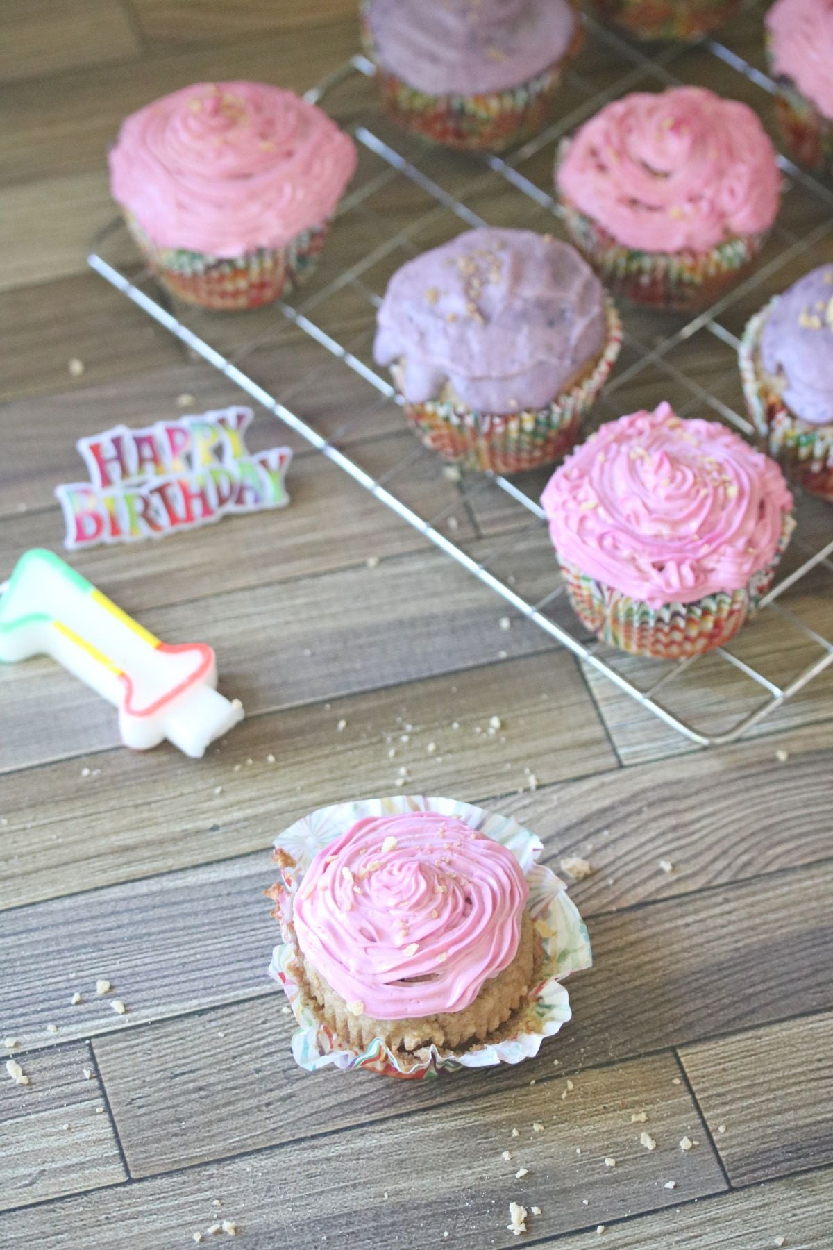 Pink and purple cupcakes with a firth birthday sign.