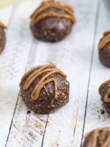 Chocolate balls with dairy-free caramel sauce piped onto them.