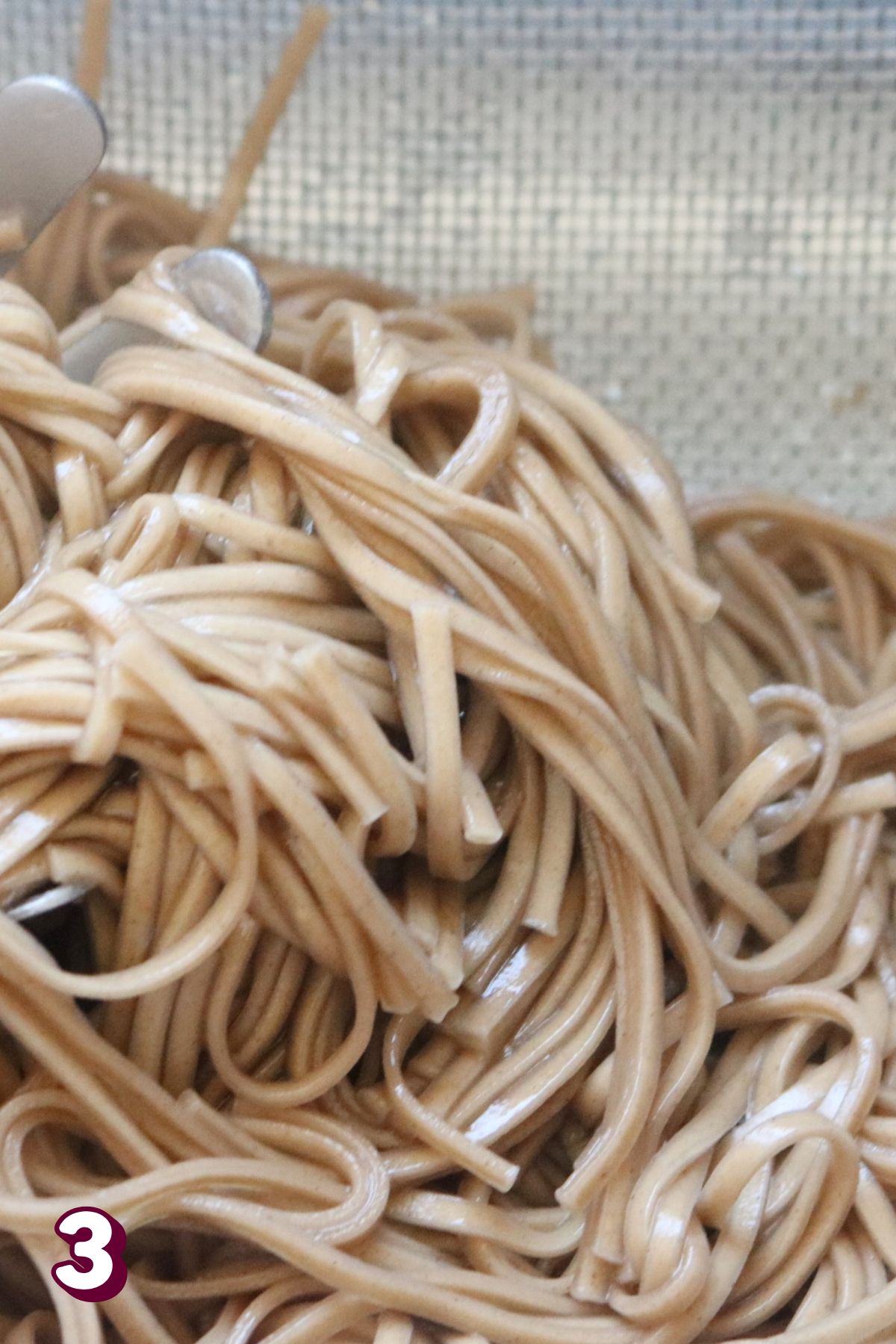 Soba noodles in a strainer.