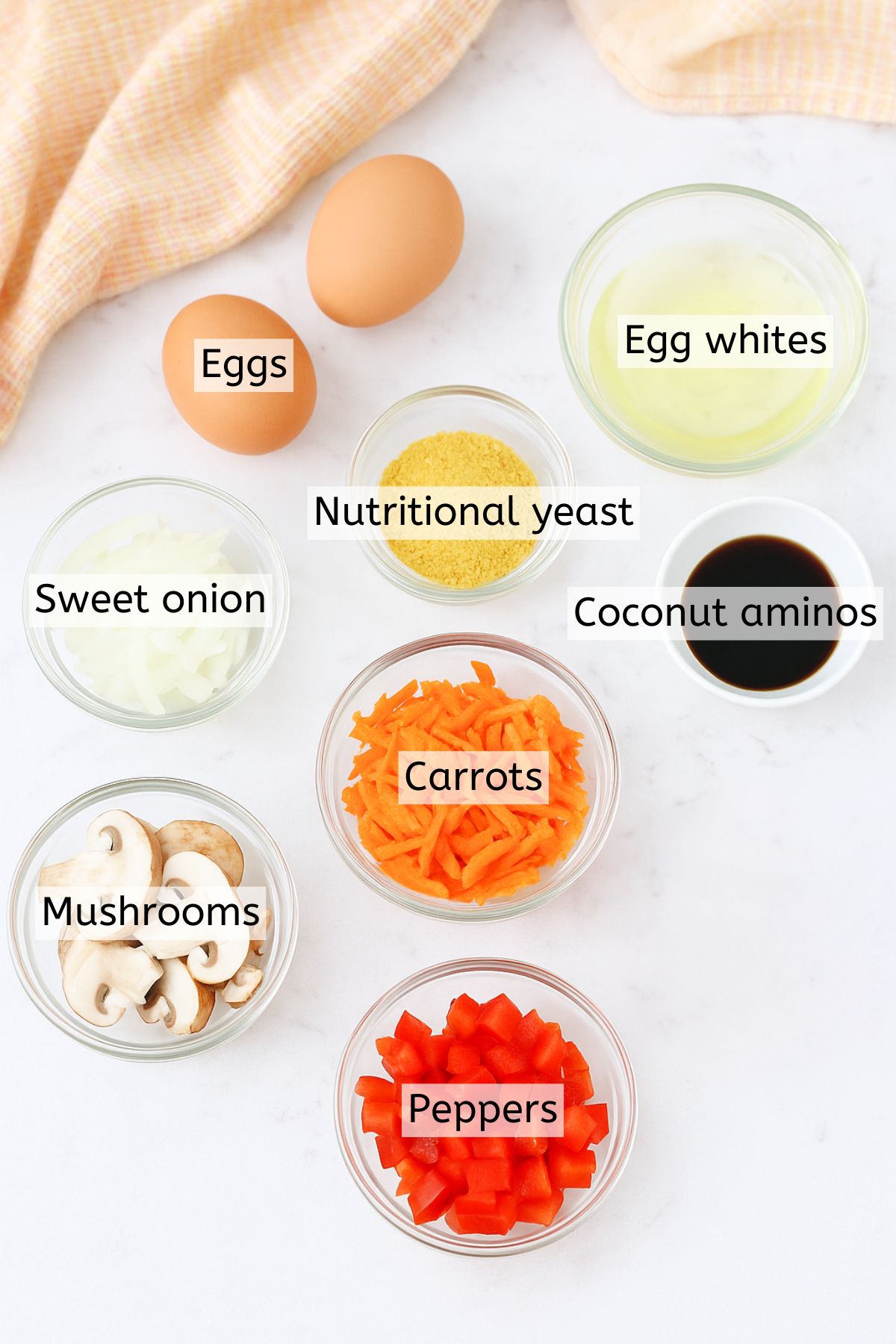 Ingredients like vegetables, soy sauce, and egg whites in bowls with text labels over top.