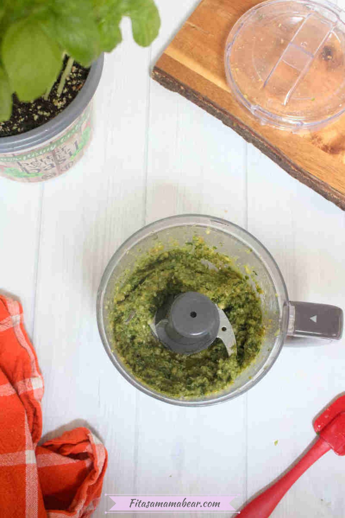 Mini food processor with pine nut-free pesto sauce in it.