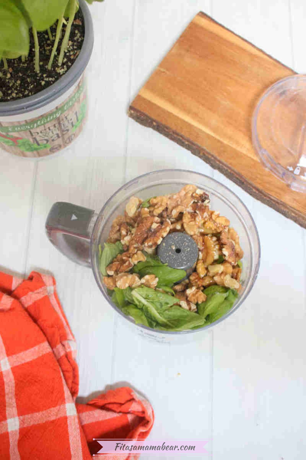 Walnuts, spinach, and basil in a mini food processor.