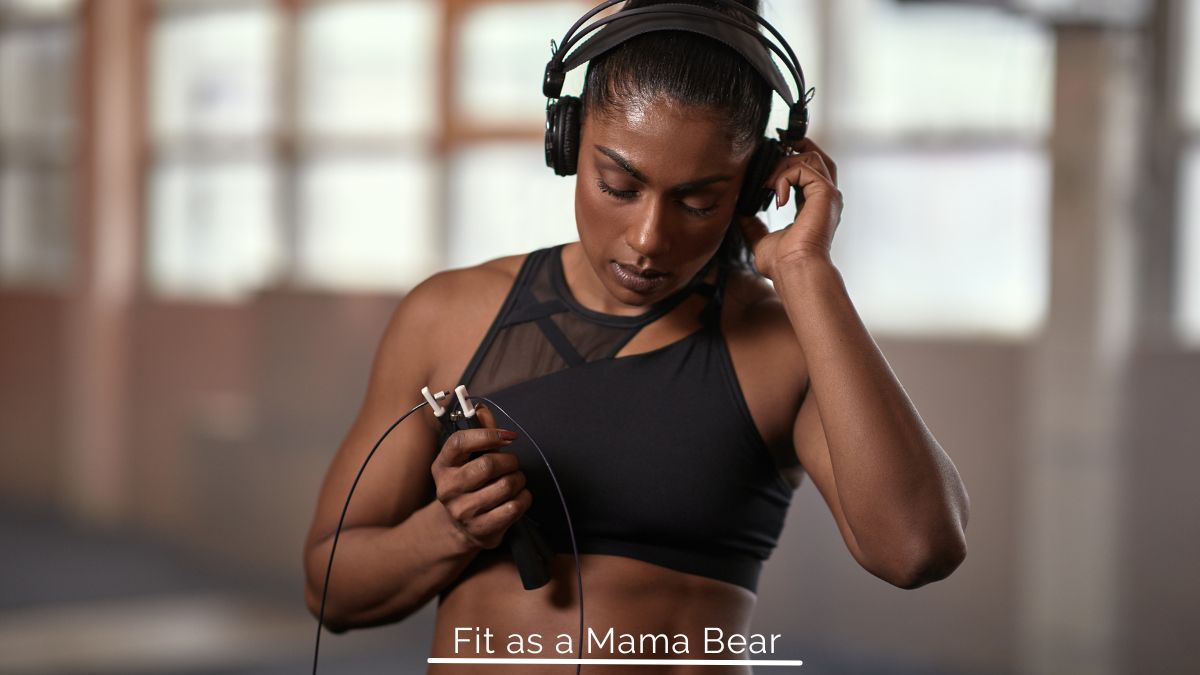 Woman in sports bra with headphones on her head.