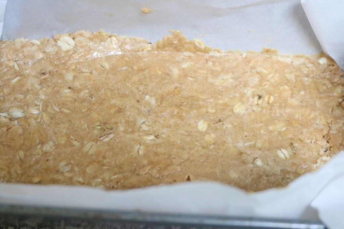 No-bake protein bars pressed into a pan.
