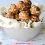 Featured image with text: cheryr vanilla energy balls stacked in a tan bowl with a tan linen