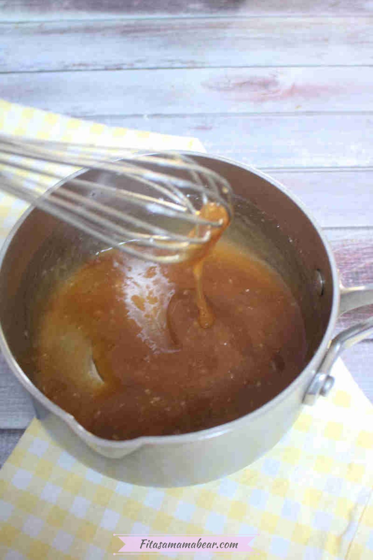 Small pot with homemade teriyaki sauce in it with a whisk.
