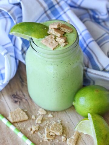 a green key lime smoothie in a clear jar.