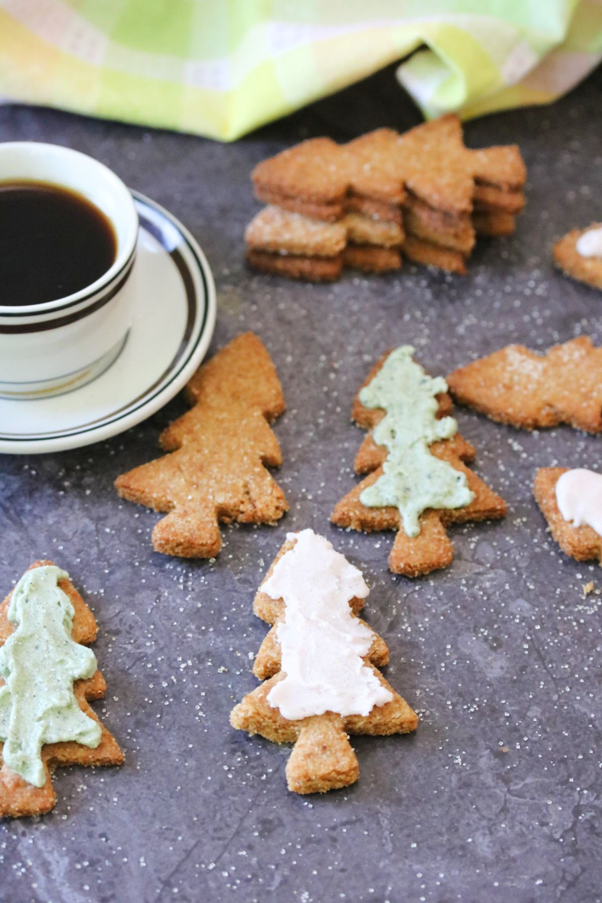 Almond flour sugar cookies in the shape of Christmas trees with colored icing.