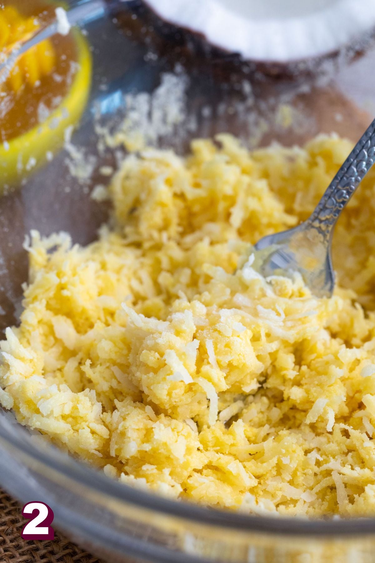Honey being poured into a bowl with protein powder and coconut flakes.