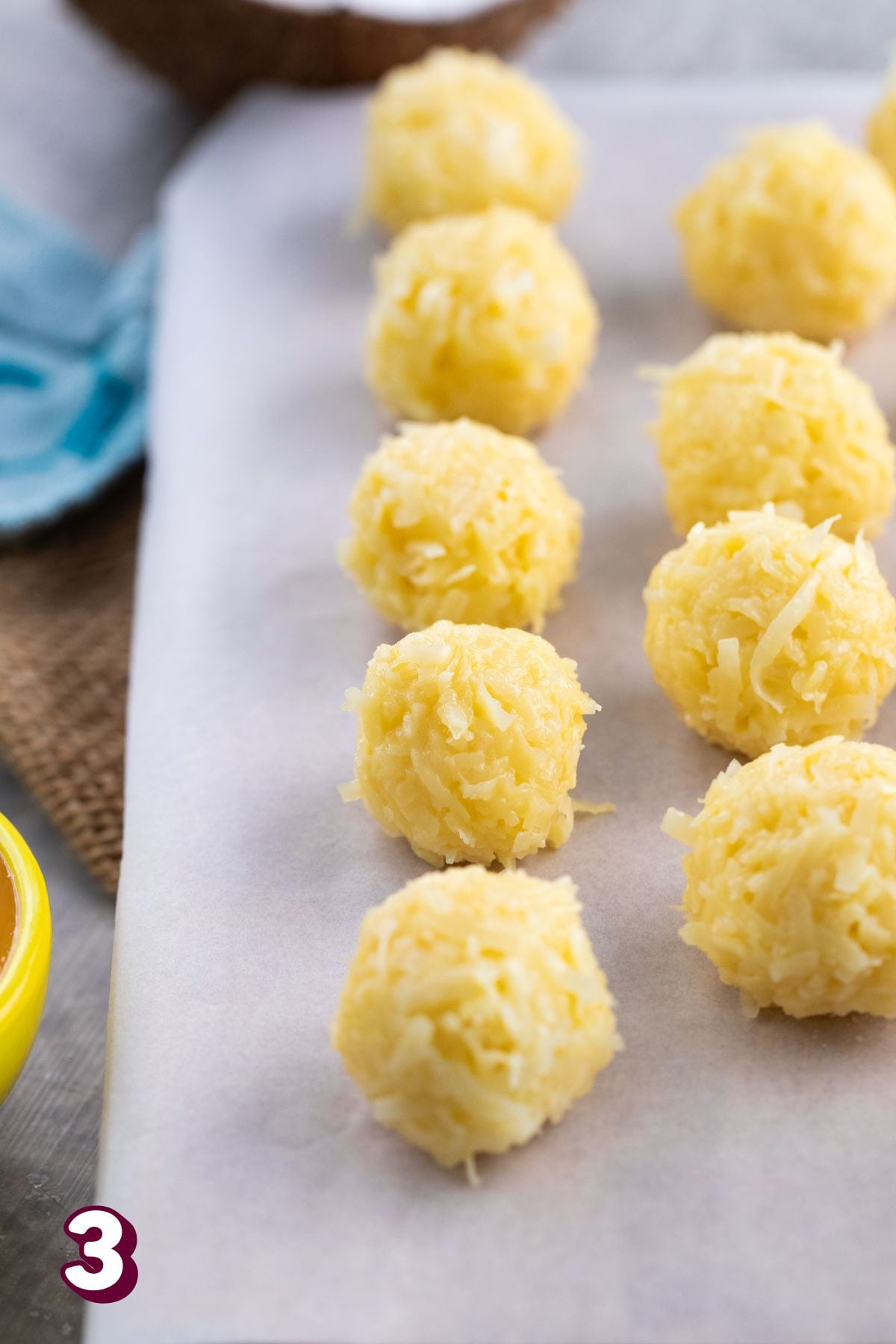 Coconut protein balls on a cutting board.