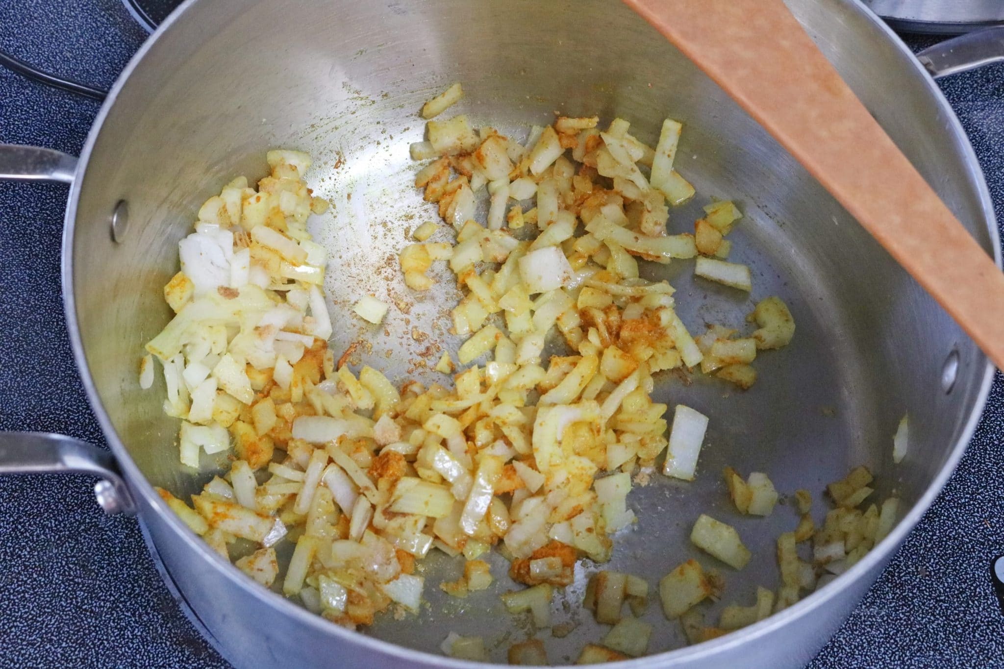In process image for beet soup: onions and garlic cooking in a large pot
