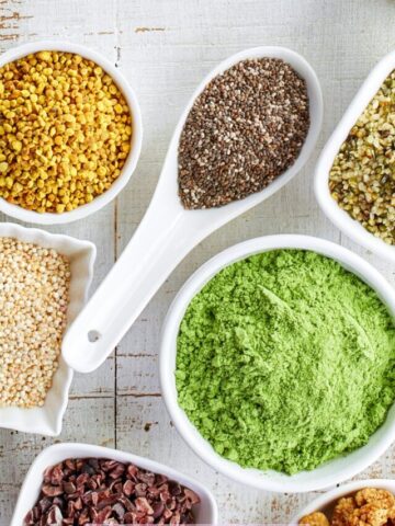 multiple superfoods in white bowls
