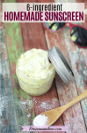 Pinterest image with text: mason jar with DIY sunscreen with zinc oxide on a wooden spoon beside it