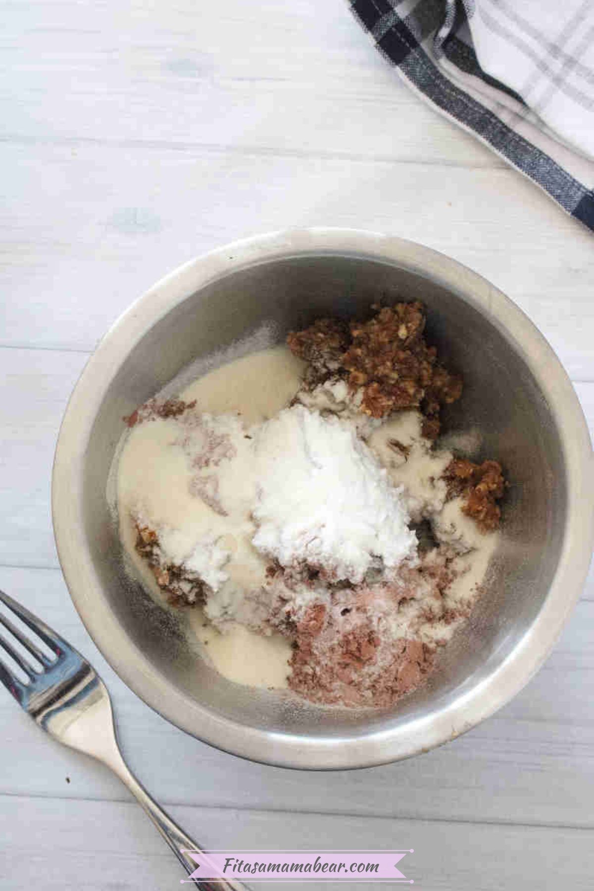 Collagen, cacao powder, and dates in a steel bowl.