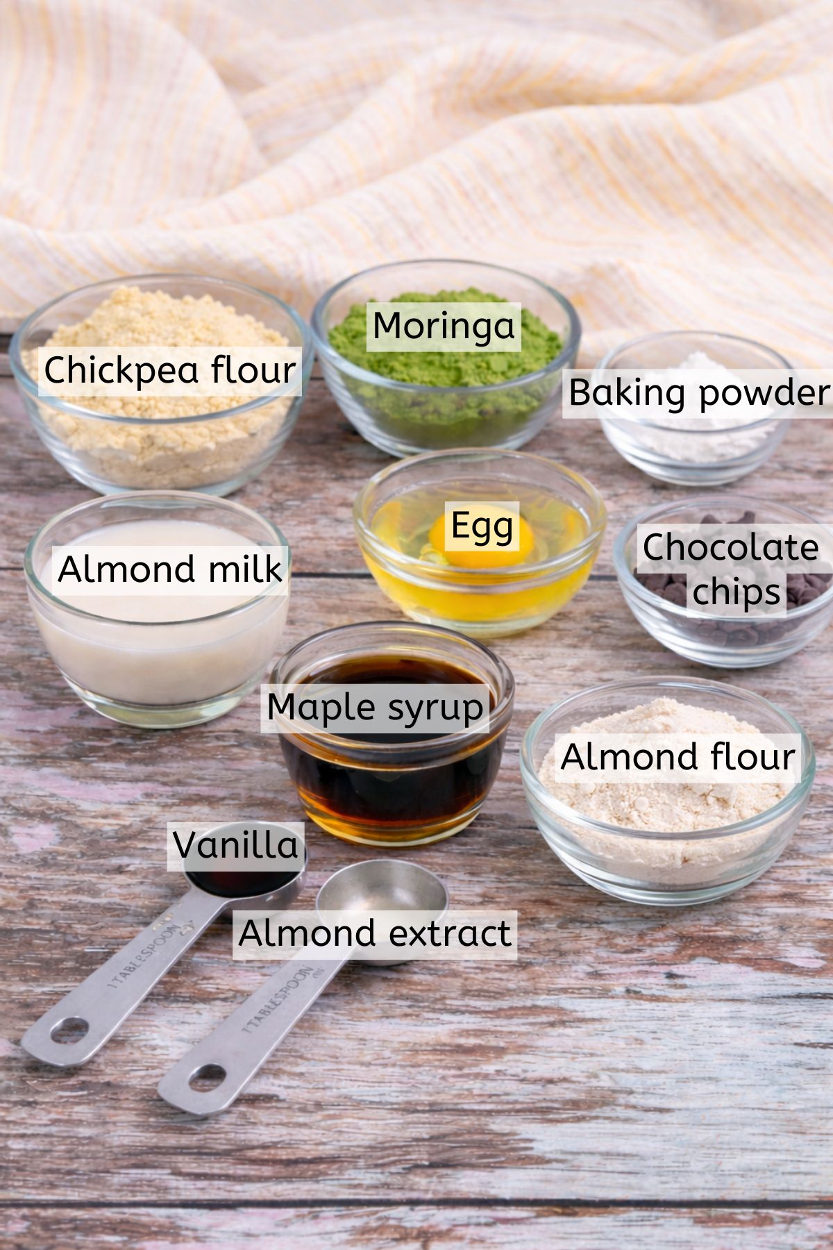 Multiple ingredients to make moringa cookies in bowls with text labels over top.