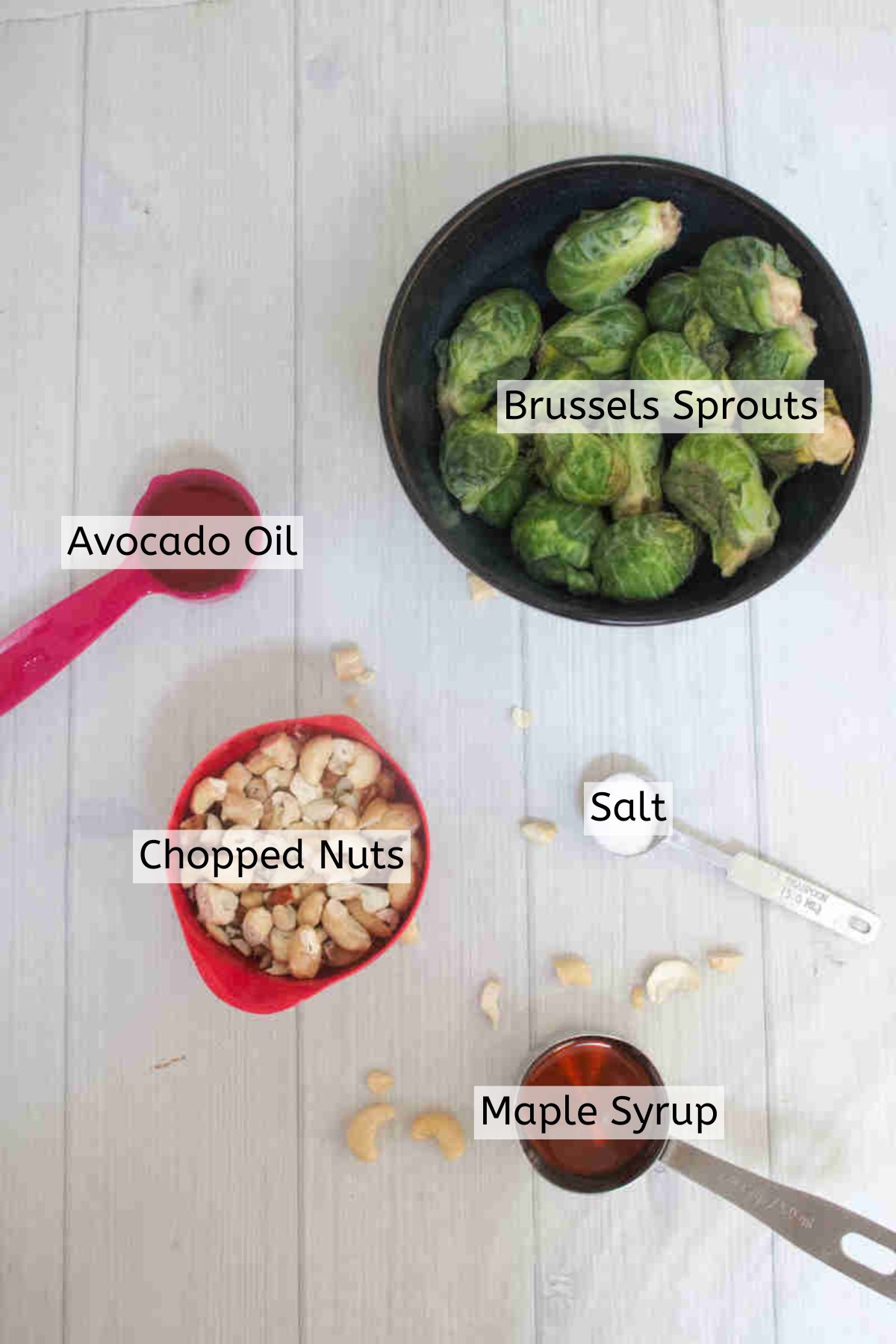 Brussels sprouts, maple syrup, and other ingredients to make candied sprouts in bowls with text labels voer top.