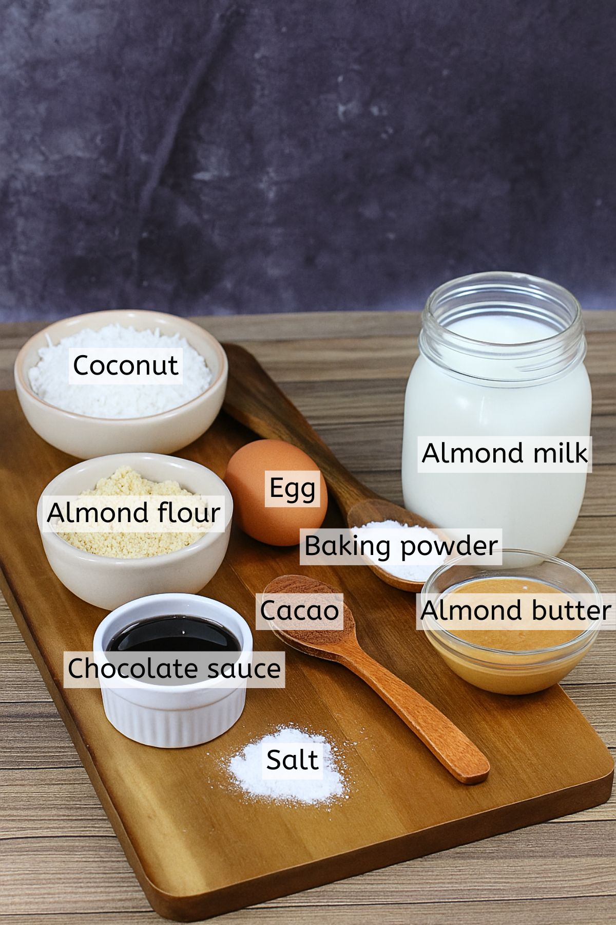 Ingredients to make coconut chocolate cookies in cups with text labels over top.
