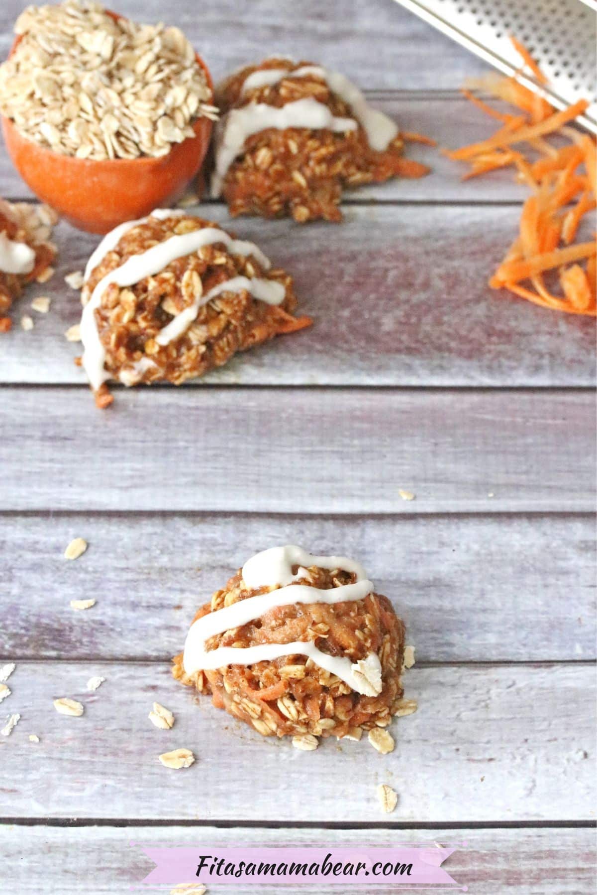 Carrot protein ball on pink muffin liner with dairy-free coconut icing