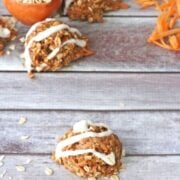 Carrot protein ball on pink muffin liner with dairy-free coconut icing