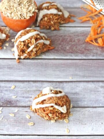 Carrot protein ball on pink muffin liner with dairy-free coconut icing