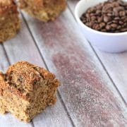Yogurt coffee cake, one square upfront and three behind it in a line next to a small bowl of coffee beans
