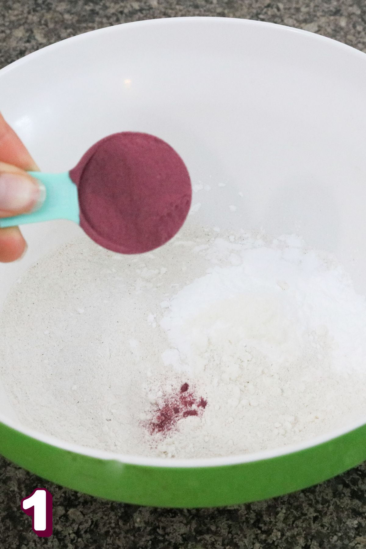 Adding beet powder to a bowl with flours.