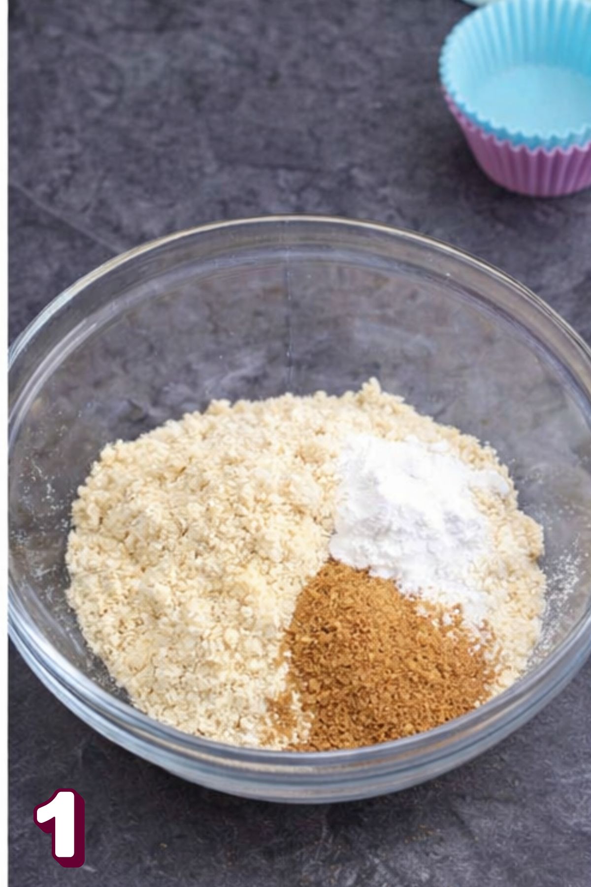 Almond flour, coconut palm sugar, and baking powder in a clear bowl.