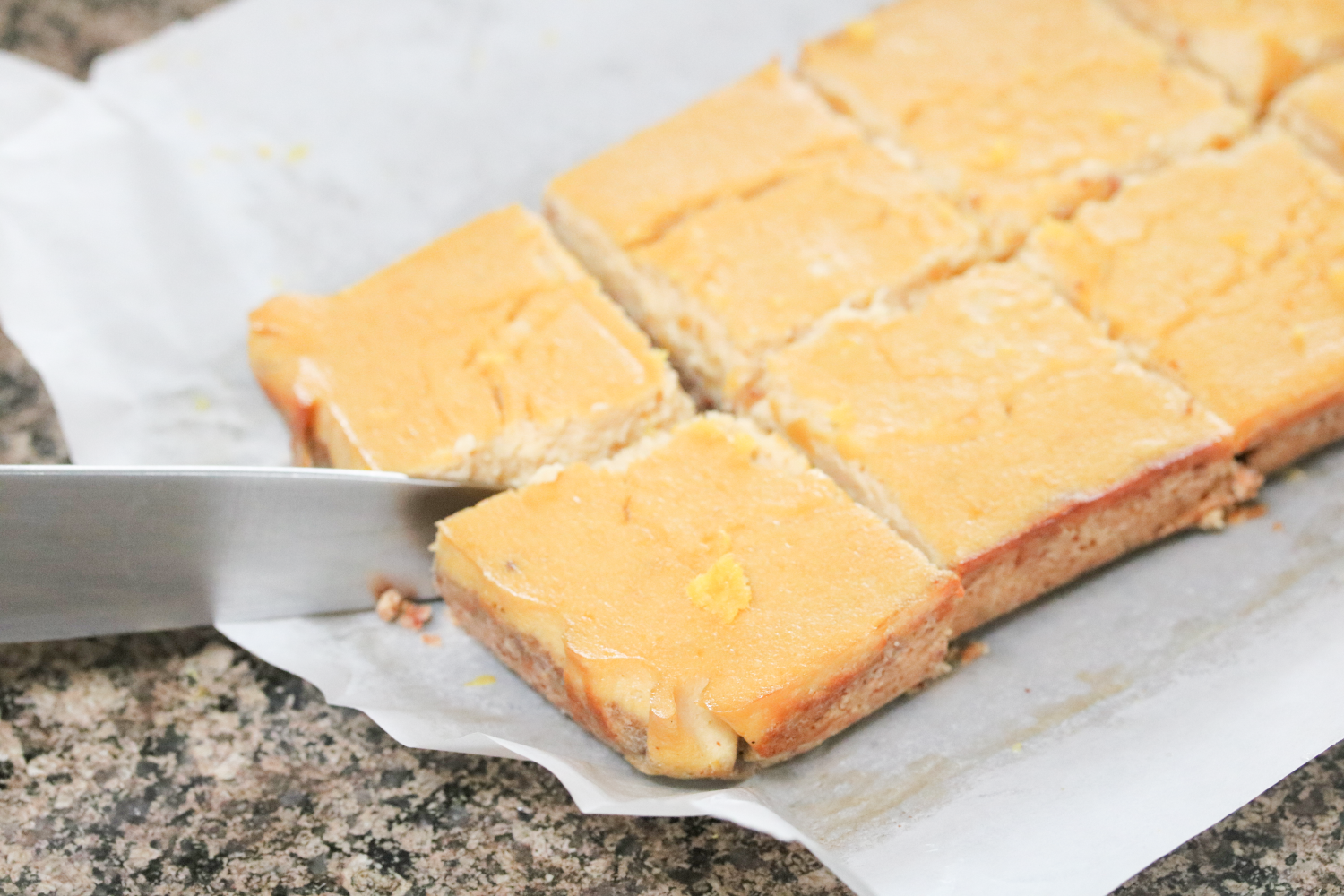 In process image for lemon bars: knife cutting cooked bars