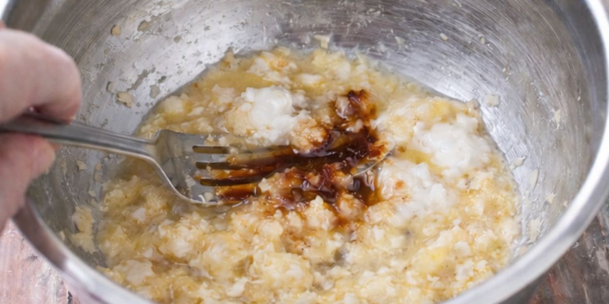 Mashed bananas and vanilla in a steel bowl.