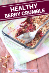 Pinterest image with text: healthy berry crisp in glass dish with a spoon on a colored napkin