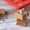 Featured image with text- hot chocolate lotion bars scattered around with chocolate chips and one silicone mold