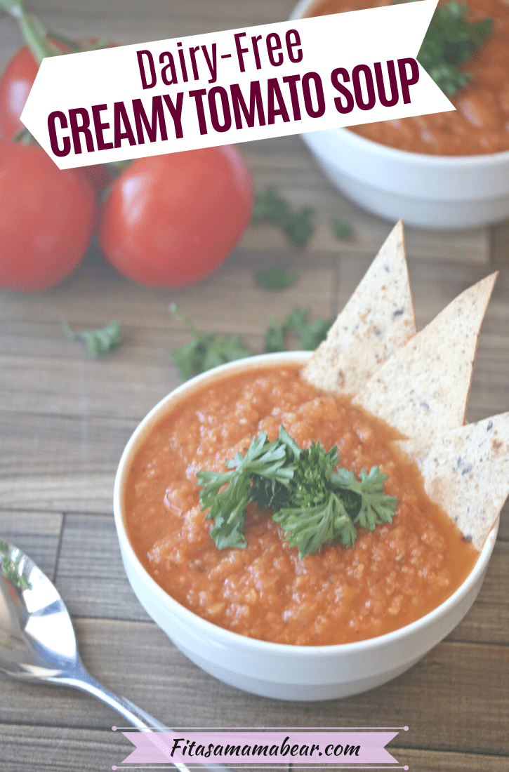 Pinterest image with text: Dairy-free tomato soup in a white bowl topped with parsley and tortilla chips with another bowl behind it and fresh tomatoes on the side