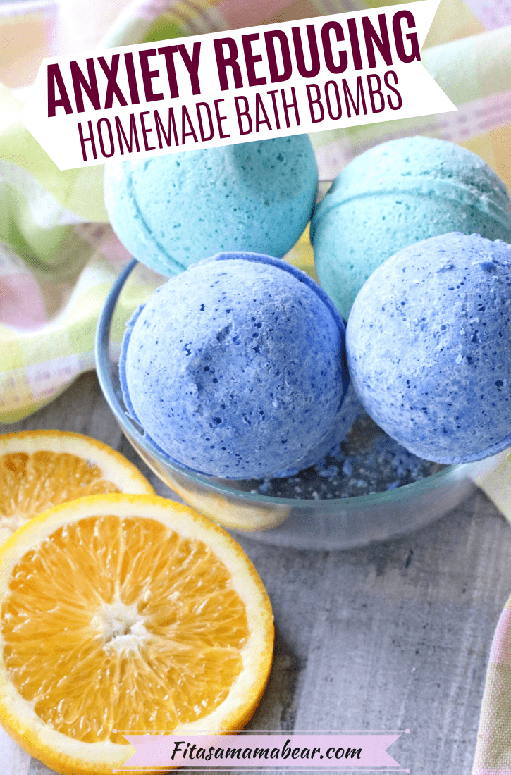 Pinterest image with text: blue and green DIY bath bombs for stress relief in a glass bowl with a green linien and sliced oranges around them