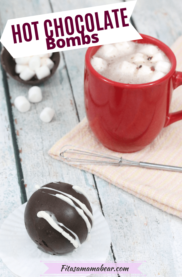 Pinterest image with text: hot chocolate bomb on a white cupcake liner with more bombs in a white bowl behind it and a red mug of hot chocolate with a whisk and marshmallows