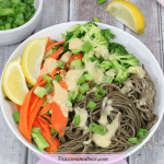 Featured image: lemon noodle bowl with veggies and green onions and lemon on the side