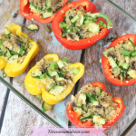 Featured image: red and yellow quinoa vegan stuffed peppers in a glass baking tray