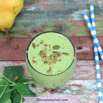 Featured image with text: simple green smoothie in a glass toopped with homemade granola with pears, spinach and blue straws on the side