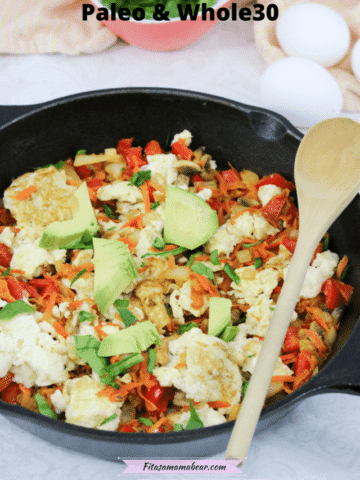 Pinterest image with text: cast iron pan with veggie and egg scramble and a wooden spoon on the side, eggs behind it