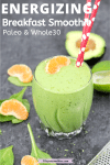 Pinterest image with text: tropical green smoothie with red straws in the glass and orange, spinach, avocado and lime around it