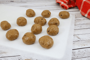 No bake cookie dough bites on a cutting board with parchment paper