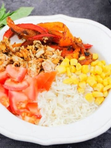 Featured image: chicken fajita bowl on rice with corn, peppers and tomatoes
