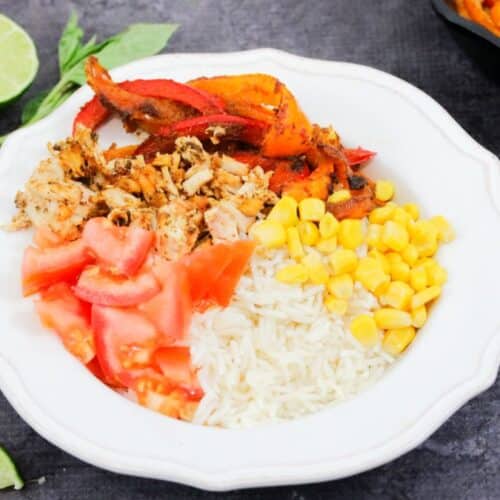 Featured image: chicken fajita bowl on rice with corn, peppers and tomatoes