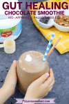 Pinterest image with text: gut-healing chocolate smoothie in a glass with toddler hands holding it