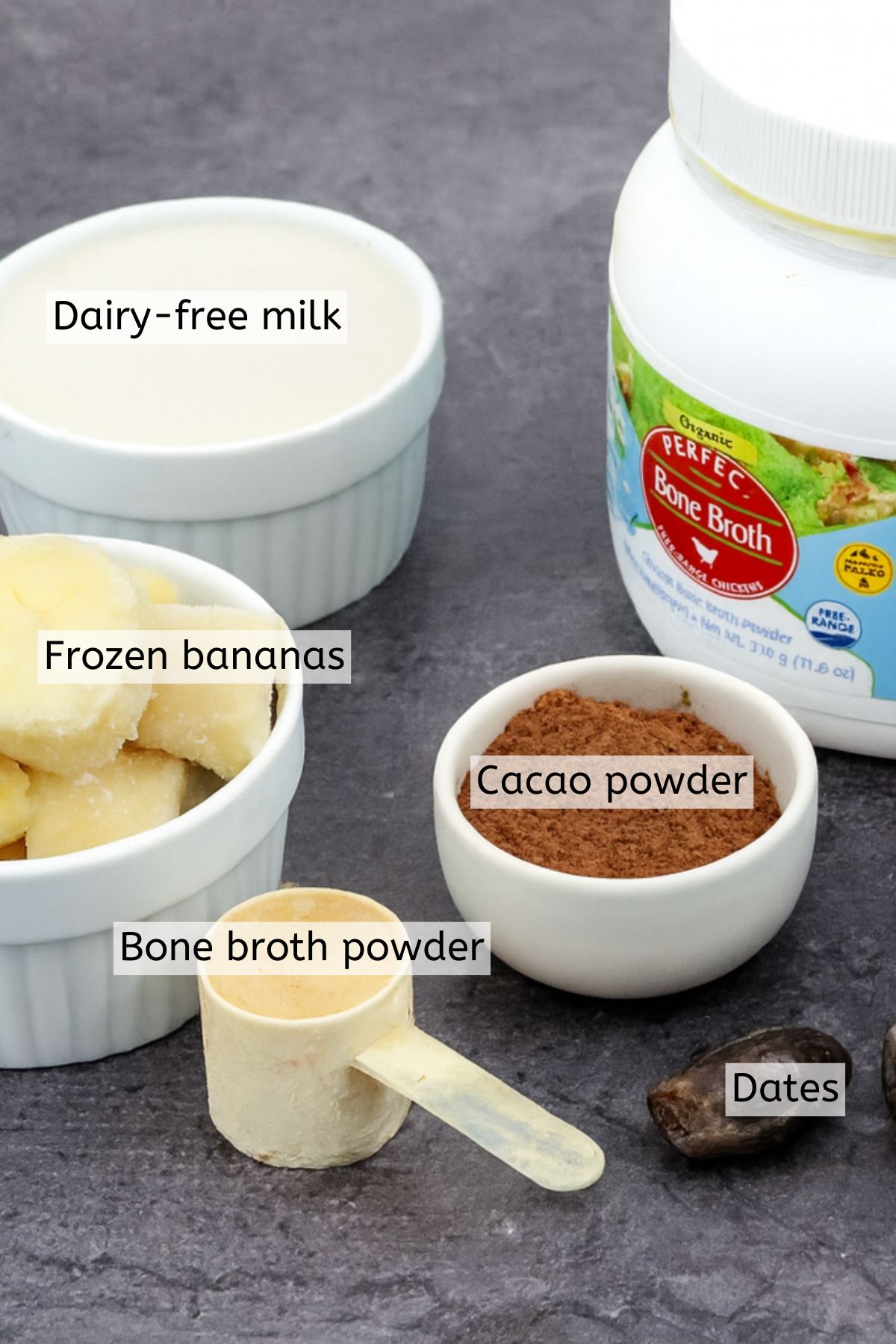 Bone broth powder, cacao powder, frozen bananas and dates all with text labels over top.