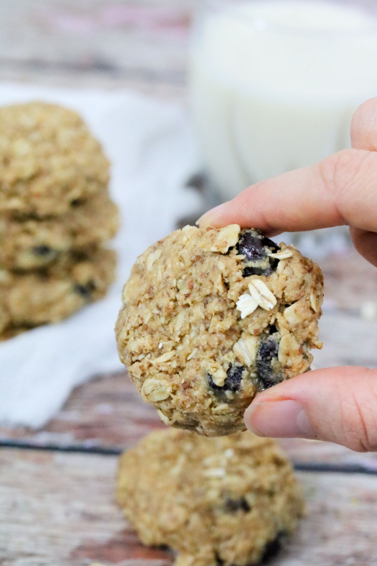 Easy lactation cookie held between two fingers.