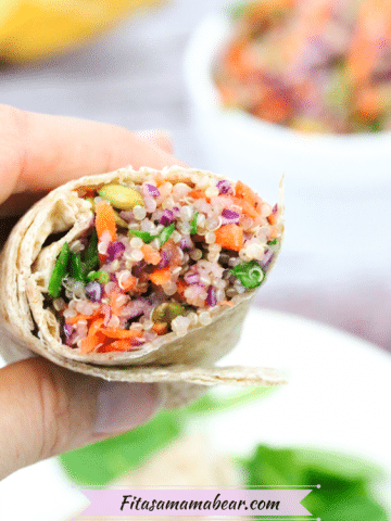 gluten-free veggie wrap with quinoa cut in half and held in a hand