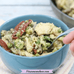 Featured image: blue bowl with dairy-free chicken aldredo with broccoli and sundried tomatoes with a spoot coming out of it