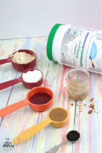 Protein powder jug surrounded by ingredients in measuring cups