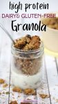 Pin image with text: Homemade granola in a small mason jar with milk in it and a spoon in the top. More granola scattered around the jar and in a beige bowl behind it