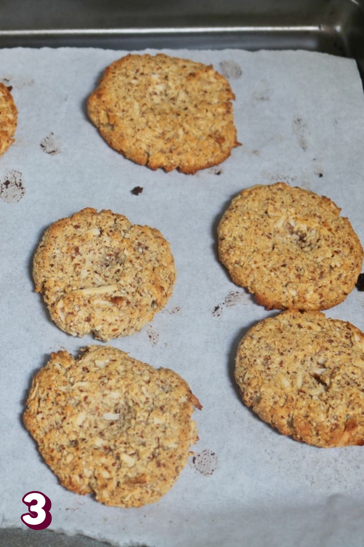 Gluten-free thumbprint cookies baked on a parchment lined tray.